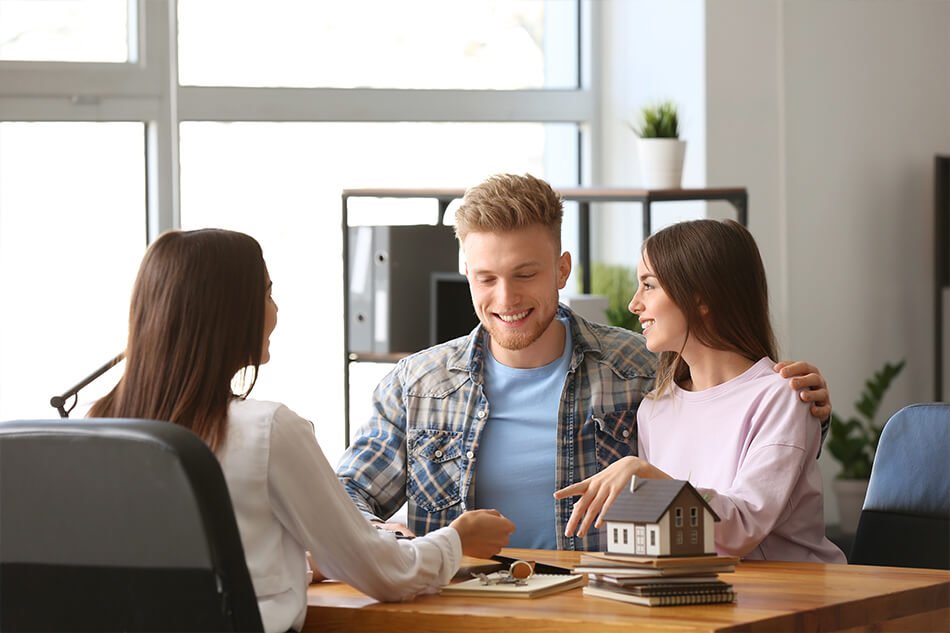 Happy couple consulting with their mortgage broker