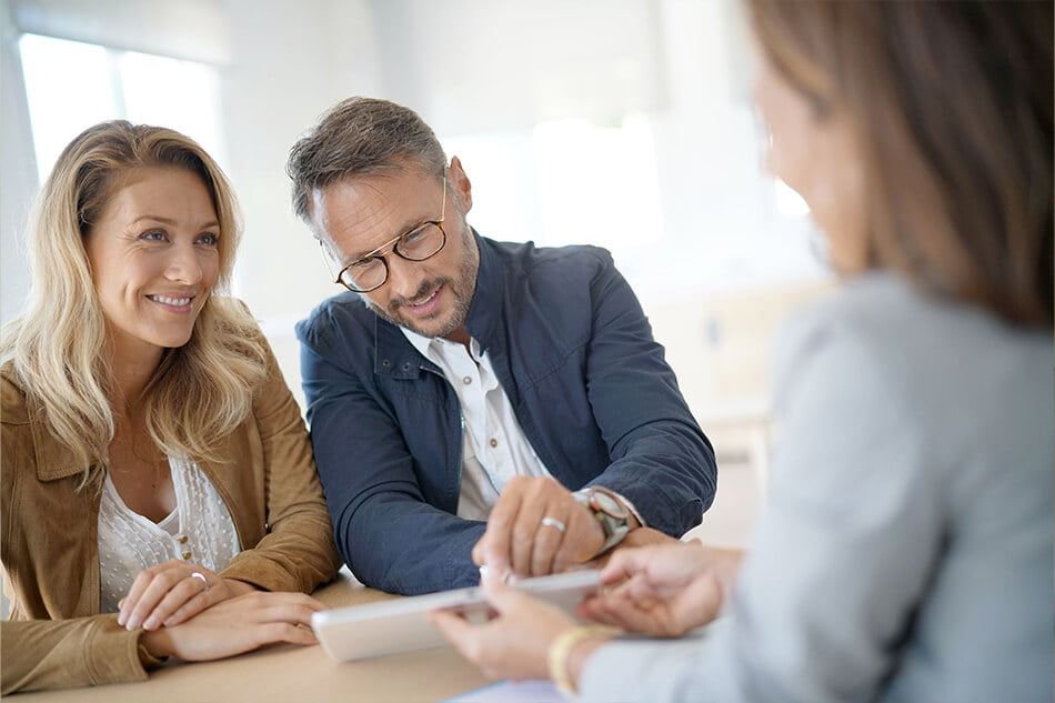 Couple consulting a local mortgage broker about their investment property loan