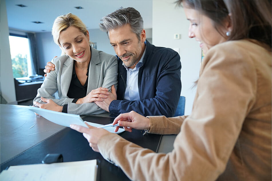 Happy couple discussing their home loan options with an expert mortgage broker