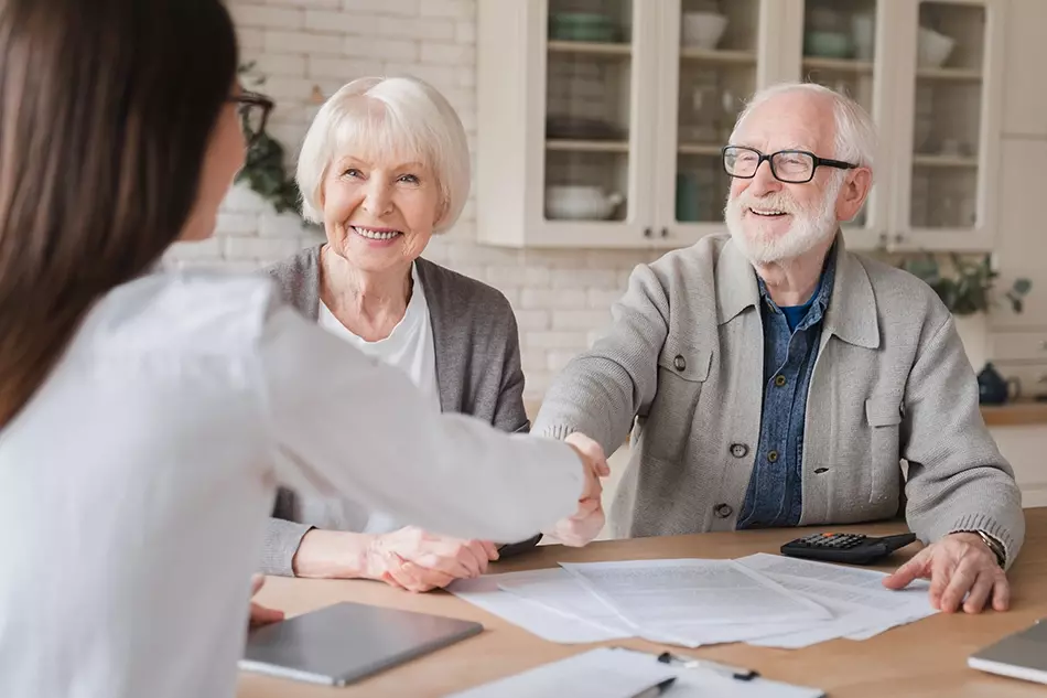 Happy senior borrowers finalising their borrowing strategy with their mortgage broker